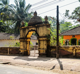 Historic village gateway surrounded by tropical greenery