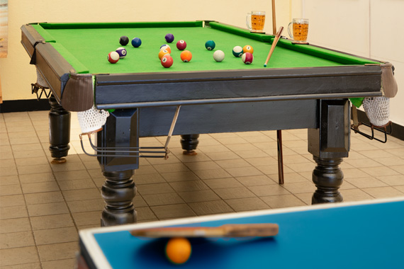 Indoor games room with a pool table and sports equipment