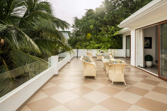 Spacious rooftop terrace with outdoor seating and lush greenery