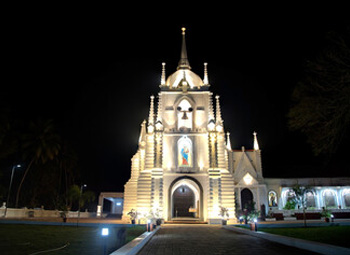 Illuminated Mae De Deus Church in Saligao at night