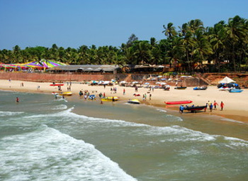 Sinquerim Beach coastline with boats and palm-lined shore
