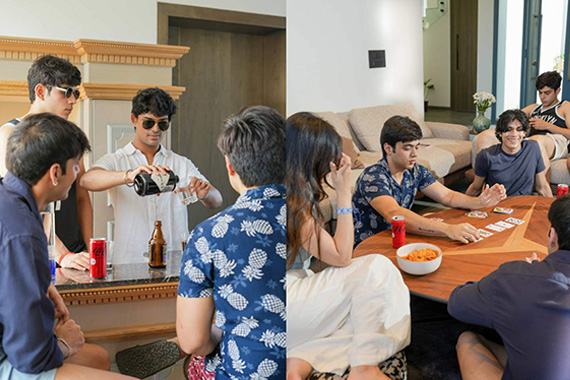 Friends enjoying drinks at the bar and playing cards during a game night in the villa