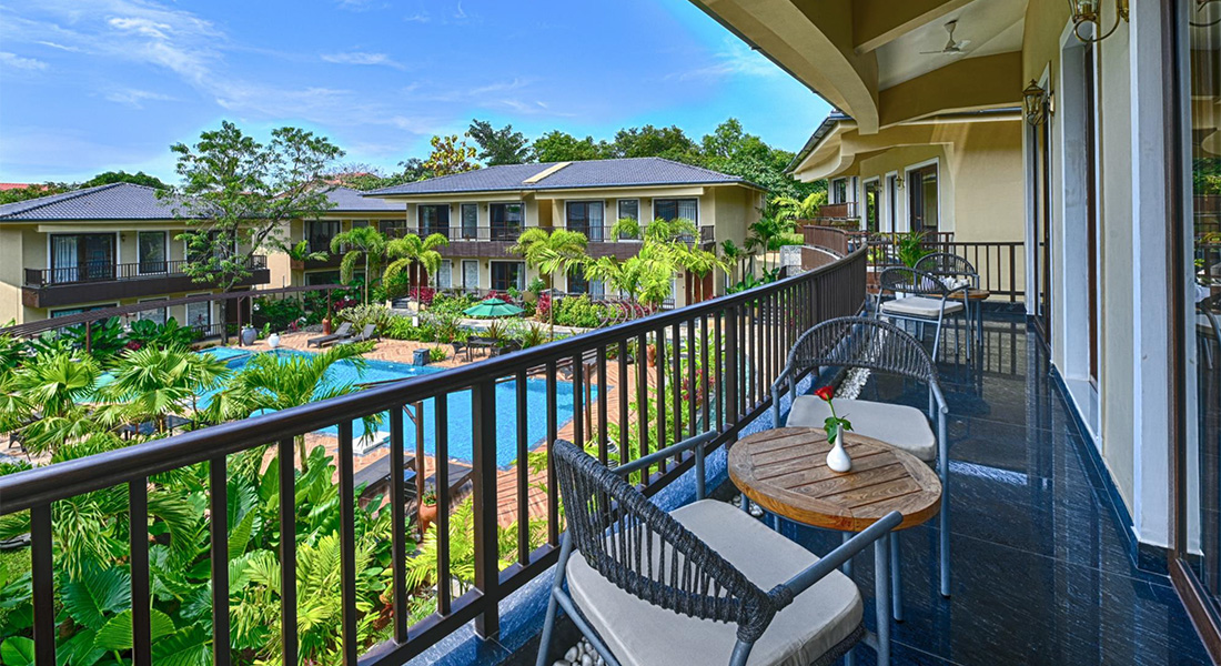 Luxury Goa villa balcony overlooking swimming pool and garden