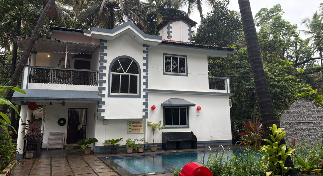 Luxury villa in Goa with private pool surrounded by palm trees near Baga Beach