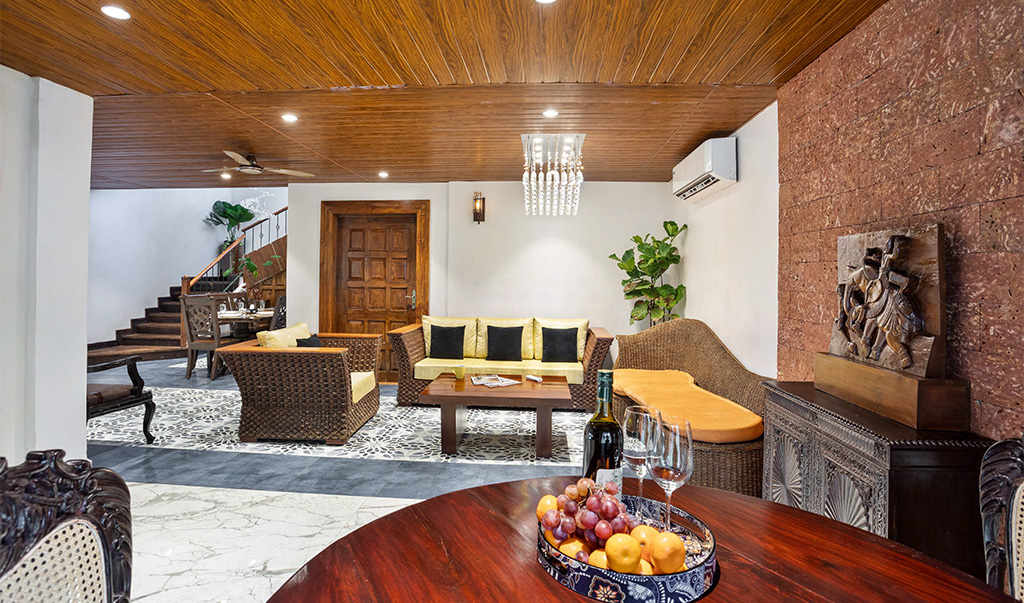 Spacious luxury villa living room with elegant furniture, wooden ceiling, and modern interiors in Goa