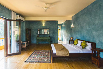 Spacious villa bedroom with blue walls near the beach