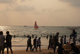 isitors enjoying water sports and beach activities at Baga Beach in Goa during sunset