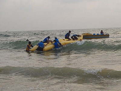 Tourists enjoying banana boat ride adventure at Baga Beach, Goa