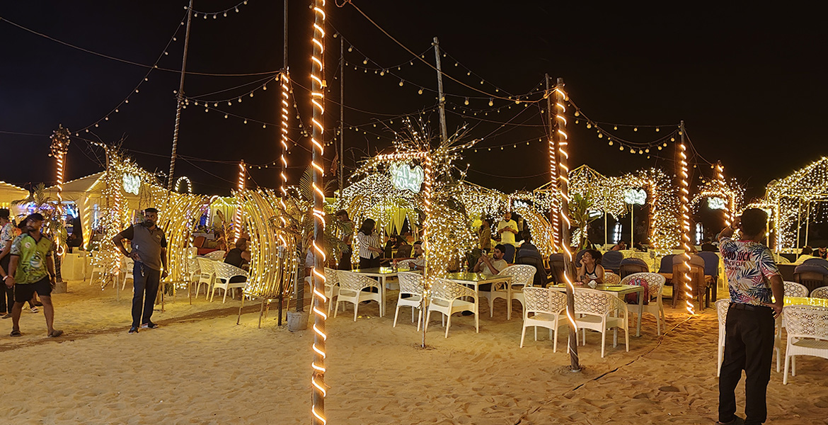 Beautiful seaside restaurant with glowing lights at Baga Beach in Goa