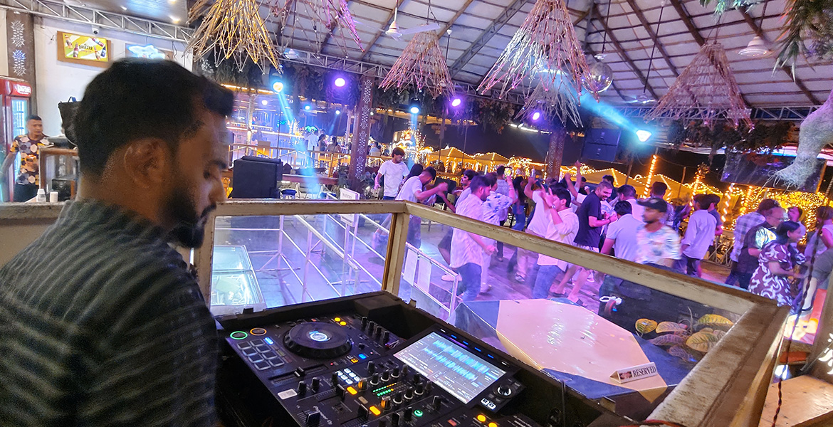 DJ playing music at a lively nightclub party near Baga Beach in Goa