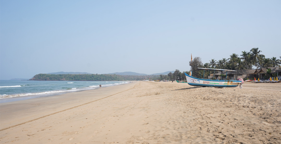 Wide coastline with fishing boat at Agonda Beach, Goa
