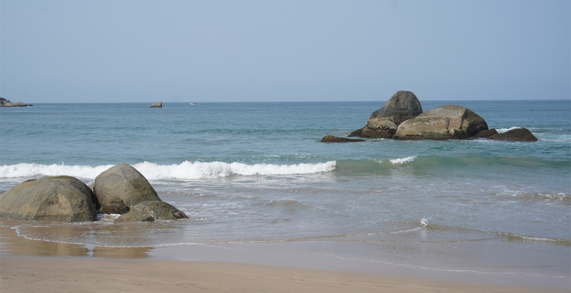 Scenic rocky shoreline and gentle waves at Agonda Beach South Goa