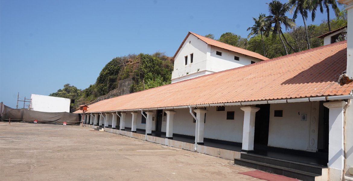 Aguada Jail Museum Goa courtyard with historic white buildings and tiled roofs
