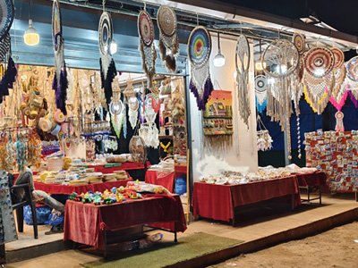Anjuna Flea Market stalls with colorful handicrafts and dreamcatchers