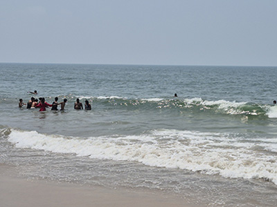 Visitors in the sea at Arambol Beach Goa