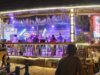 Beach bar with live music, colorful lights, and vibrant nightlife at Baga Beach Goa