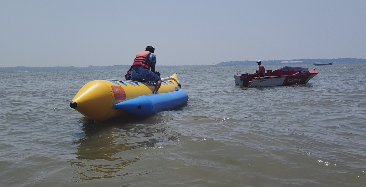 Tourist riding an inflatable banana boat