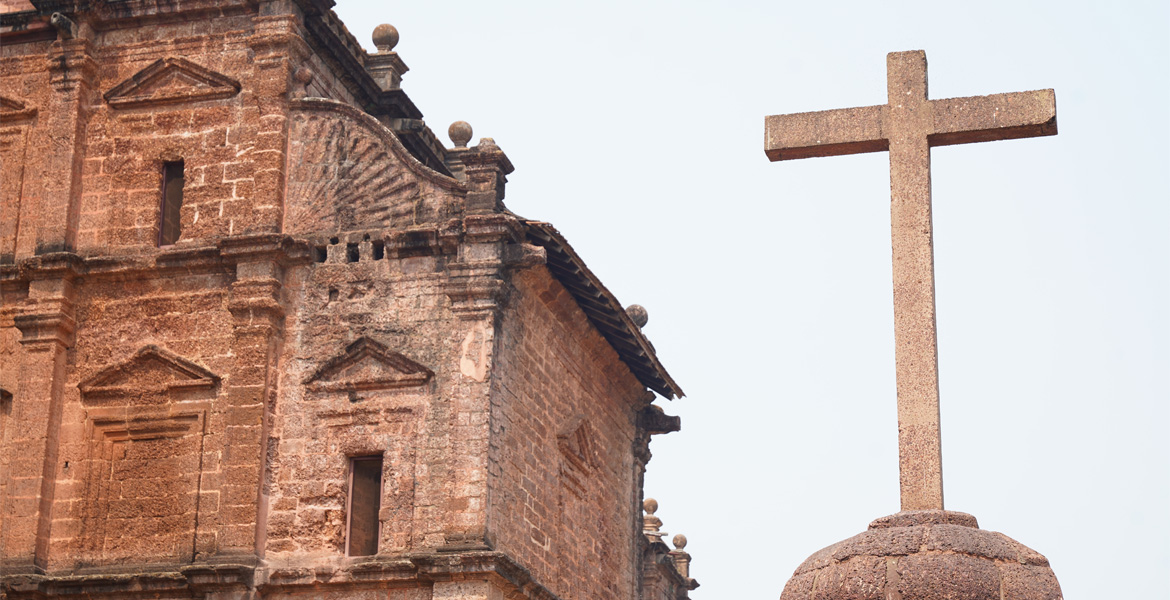 Stone cross beside the Basilica of Bom Jesus in Old Goa highlighting its historic Portuguese Christian heritage