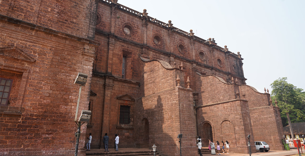 Side view of the Basilica of Bom Jesus in Old Goa showcasing its historic laterite stone Baroque architecture