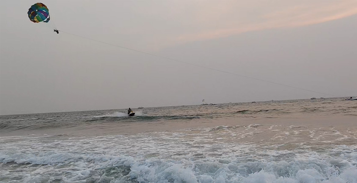 Parasailing and jet ski activities on the Arabian Sea at Benaulim Beach Goa during sunset