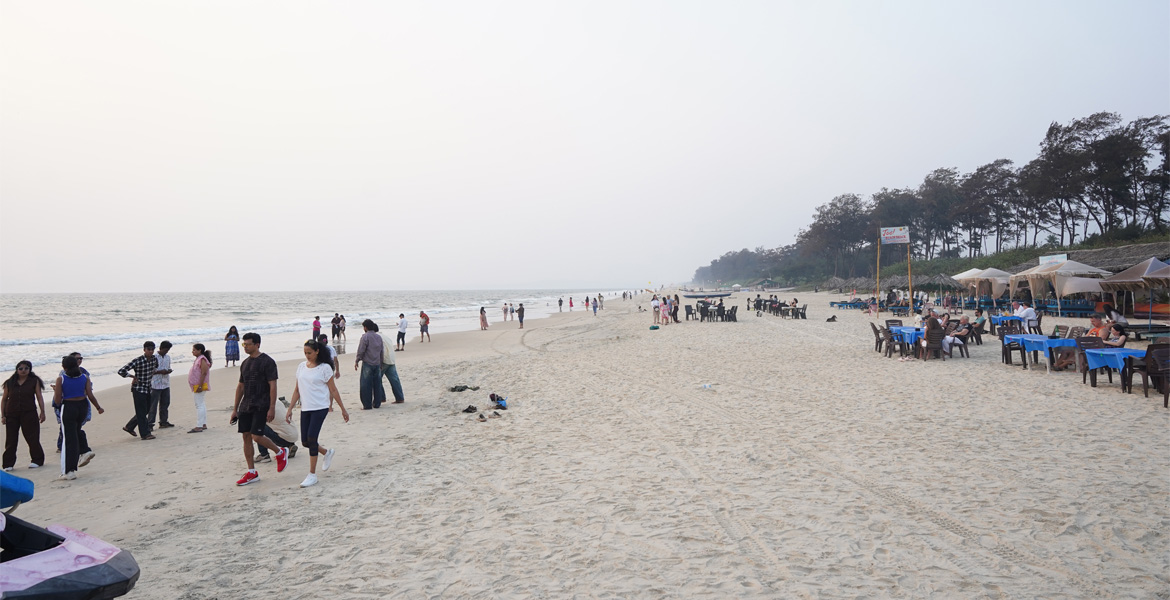 Visitors enjoying the evening at Betalbatim Beach, Goa