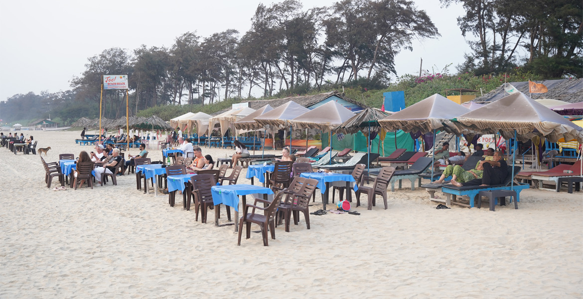 Beach shacks and outdoor seating at Betalbatim Beach, Goa