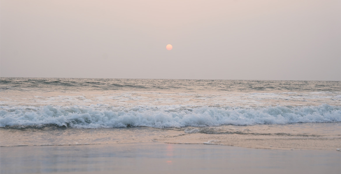 Sunset over Betalbatim Beach waves