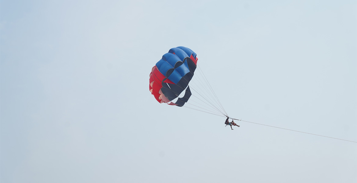 Couple parasailing above the sea