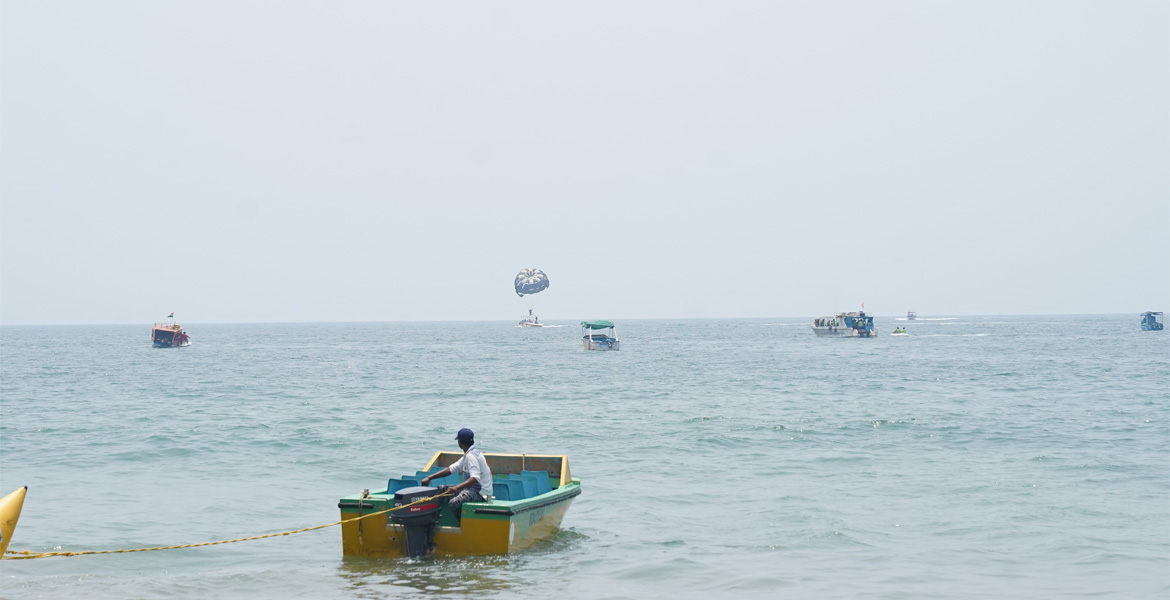 Parasailing activity, boats, and water sports at Bogmalo Beach Goa along the Arabian Sea