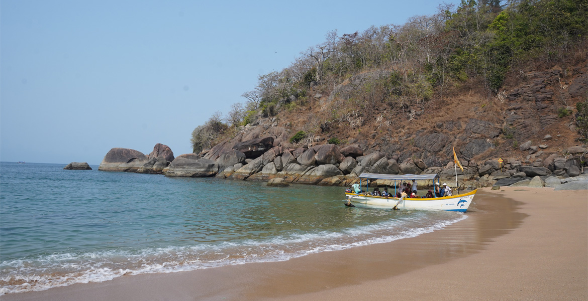 Boat at the rocky shore of Butterfly Beach, Goa