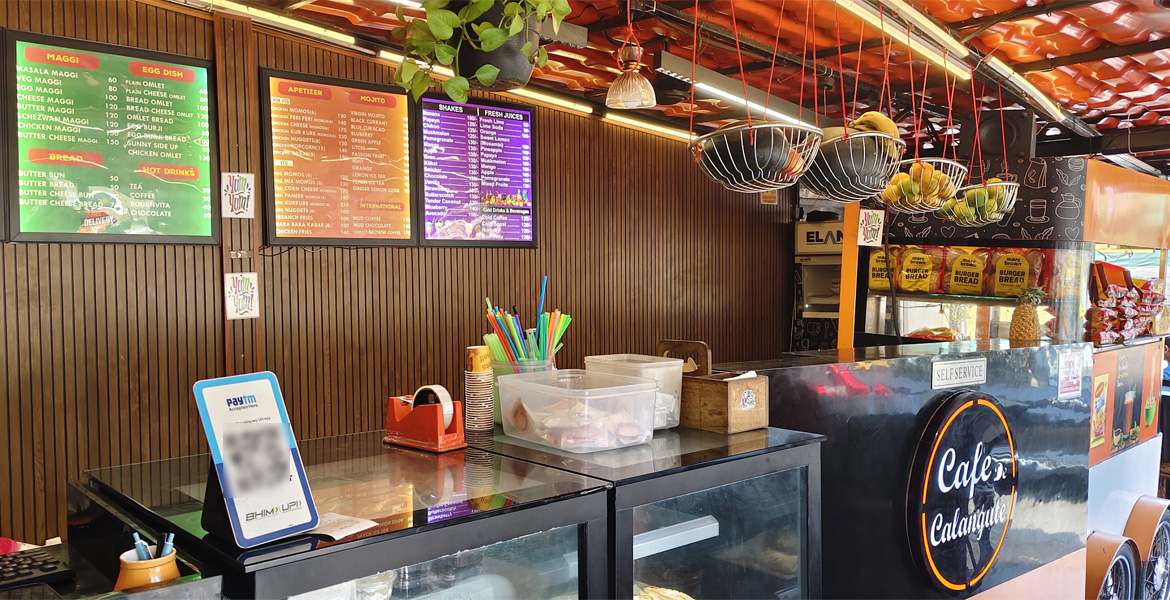 Cafe Calangute interior with menu boards and food counter