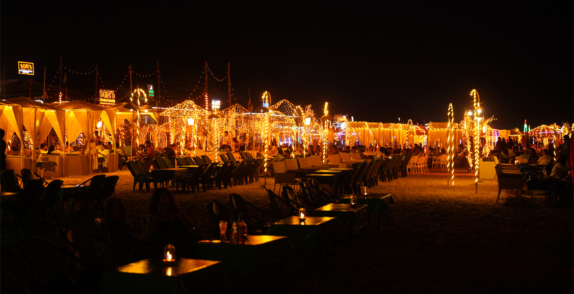 Candlelight dinner setup on a Goa beach at night