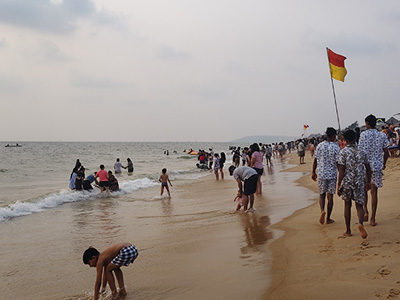 Visitors enjoying Candolim Beach in Goa