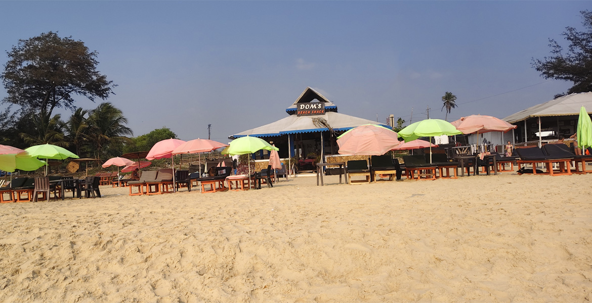 Beach shack with colorful umbrellas at Cavelossim Beach, Goa