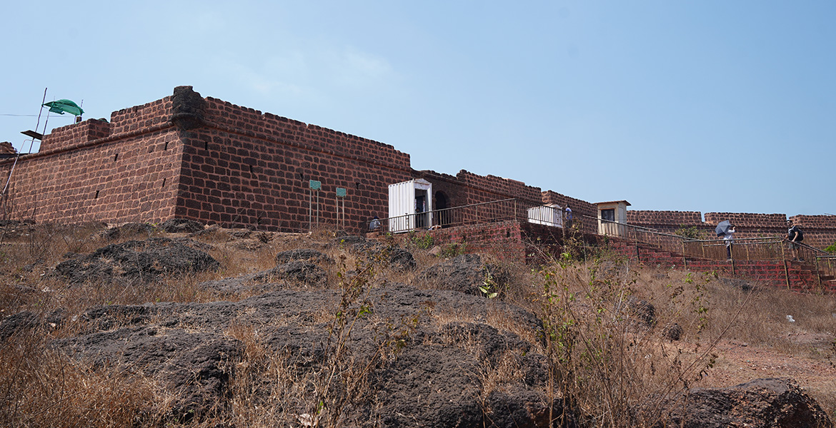 Historic stone walls and dry rocky landscape at Chapora Fort in Goa