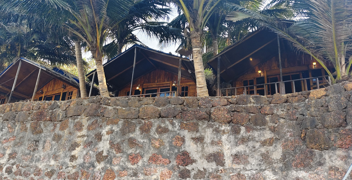 Beachfront stay with palm trees at Cola Beach, Goa
