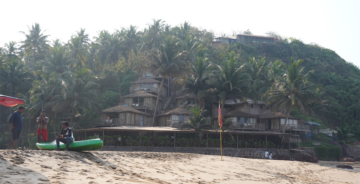 Beach resort with palm trees at Cola Beach, Goa