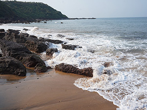 Waves along the rocky shore at Cola Beach, Goa.