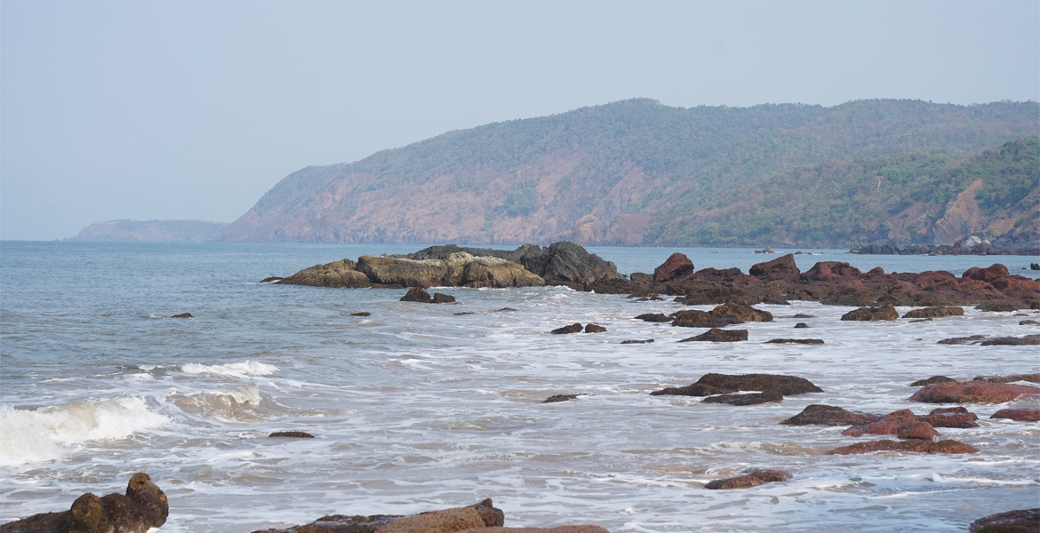 Rocky shoreline and sea view at Cola Beach, Goa