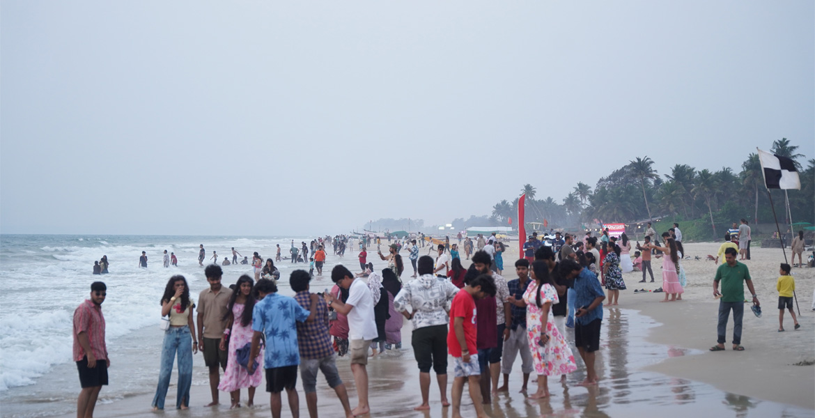 Evening visitors along the shoreline at Colva Beach, Goa