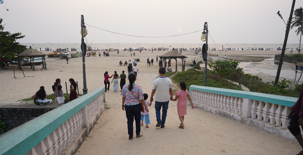 Colva Beach Goa with family walking on sandy path toward the beach