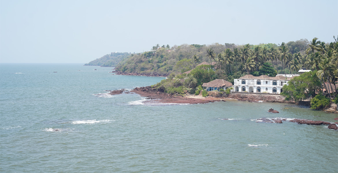 Scenic coastal view from Dona Paula Viewpoint featuring the Arabian Sea and lush shoreline in Goa