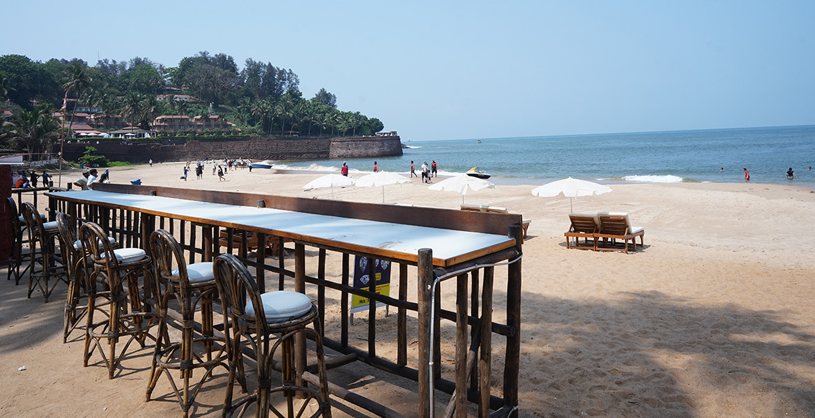 Beachside restaurant seating area with scenic coastal view near Fort Aguada in Goa