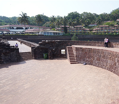 Stone pathways and curved fort walls at the historic Fort Aguada in Goa