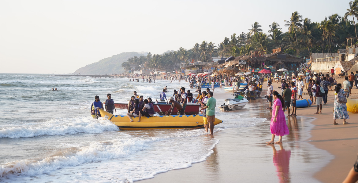 Banana boat activity on a crowded Goa beach