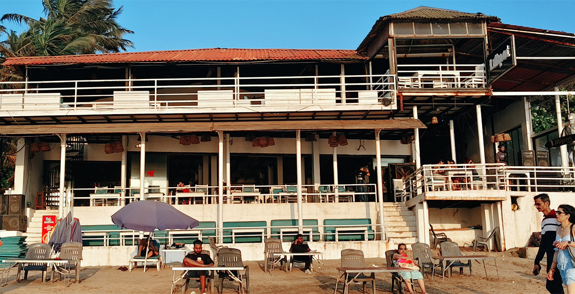 Goa beach club with open-air seating and palm trees