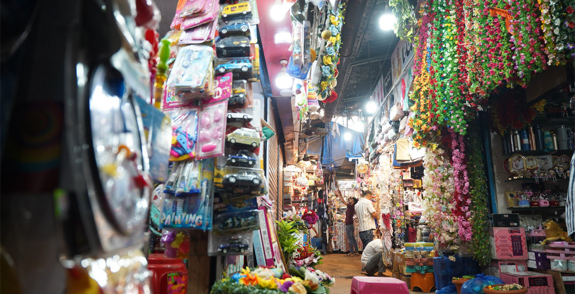 Goa market with colourful flower garlands toys and shopping stalls