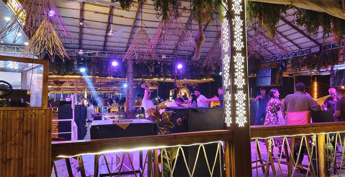 Goa nightlife venue with people dancing under colourful lights