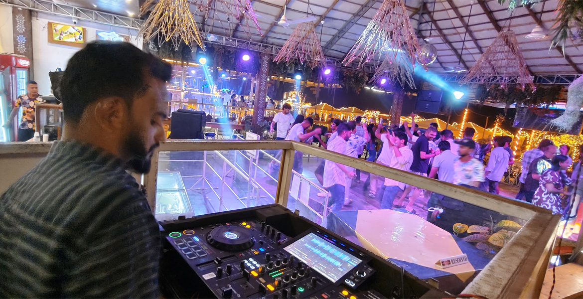 DJ playing music at a lively Goa nightlife party