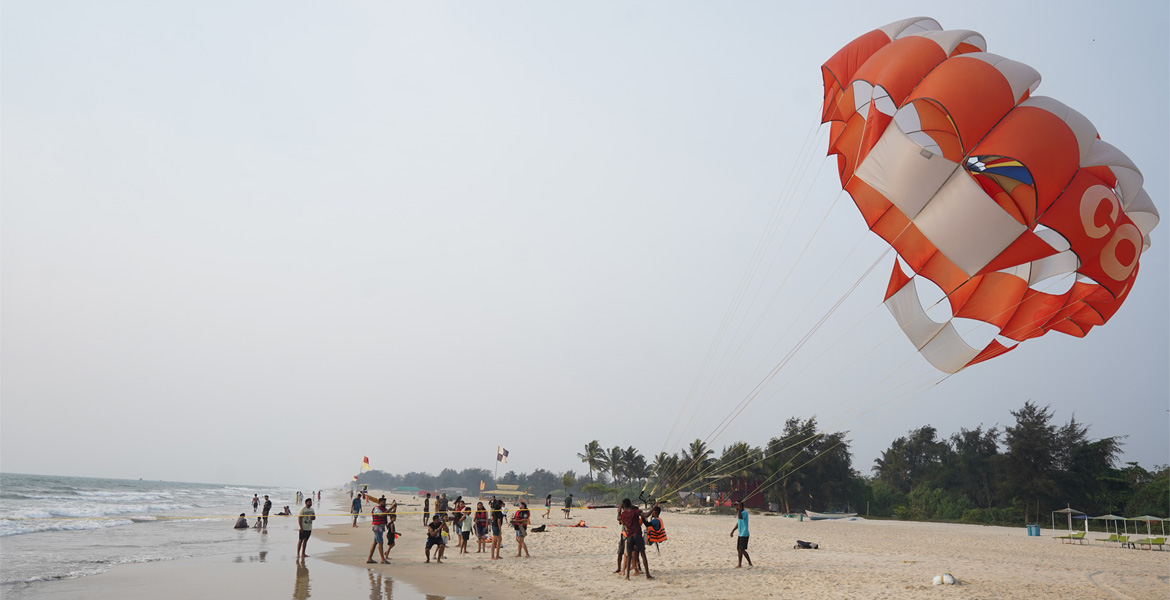 Tourists enjoying parasailing at the beach
